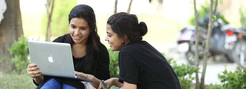 Two Girls learn in apple laptop